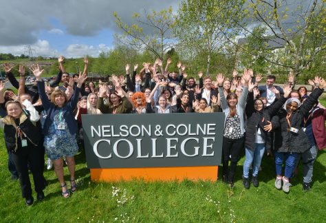 Photo of students and staff from Nelson and Colne College Group celebrating their recent 'Outstanding' Ofsted rating